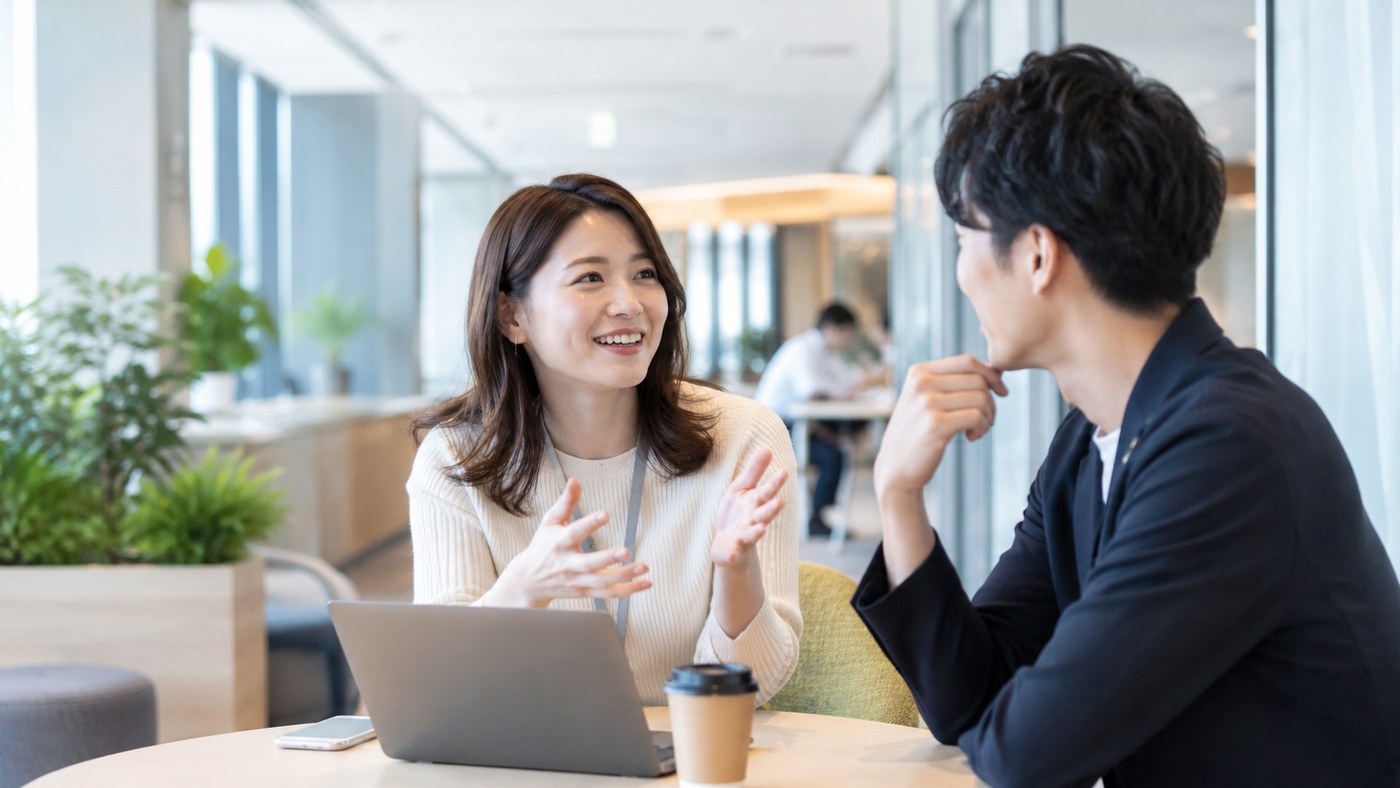 社内の別部署の仕事について話を聞く会社員